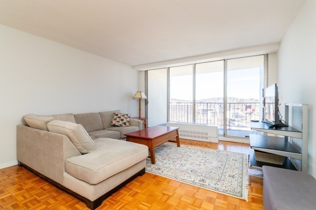 33 Pond Avenue, Unit 1106 Brookline, MA 02445 - Photo 14 of 32 a living room with furniture and a large window