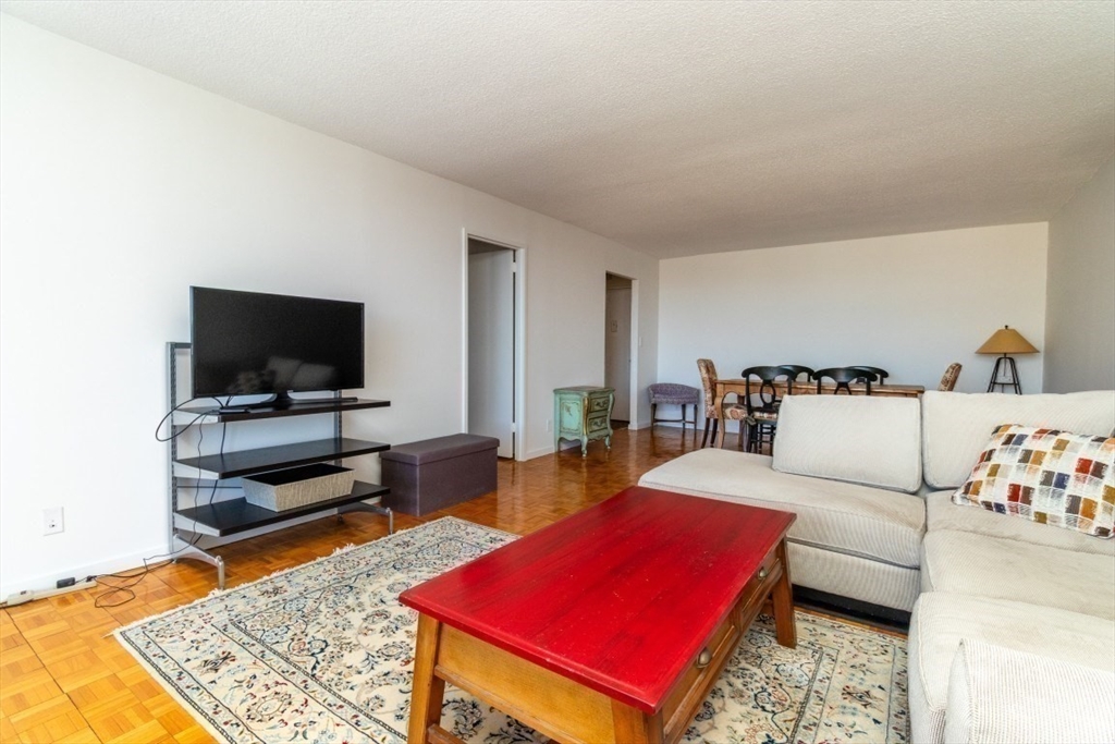 33 Pond Avenue, Unit 1106 Brookline, MA 02445 - Photo 15 of 32 a living room with furniture and a flat screen tv