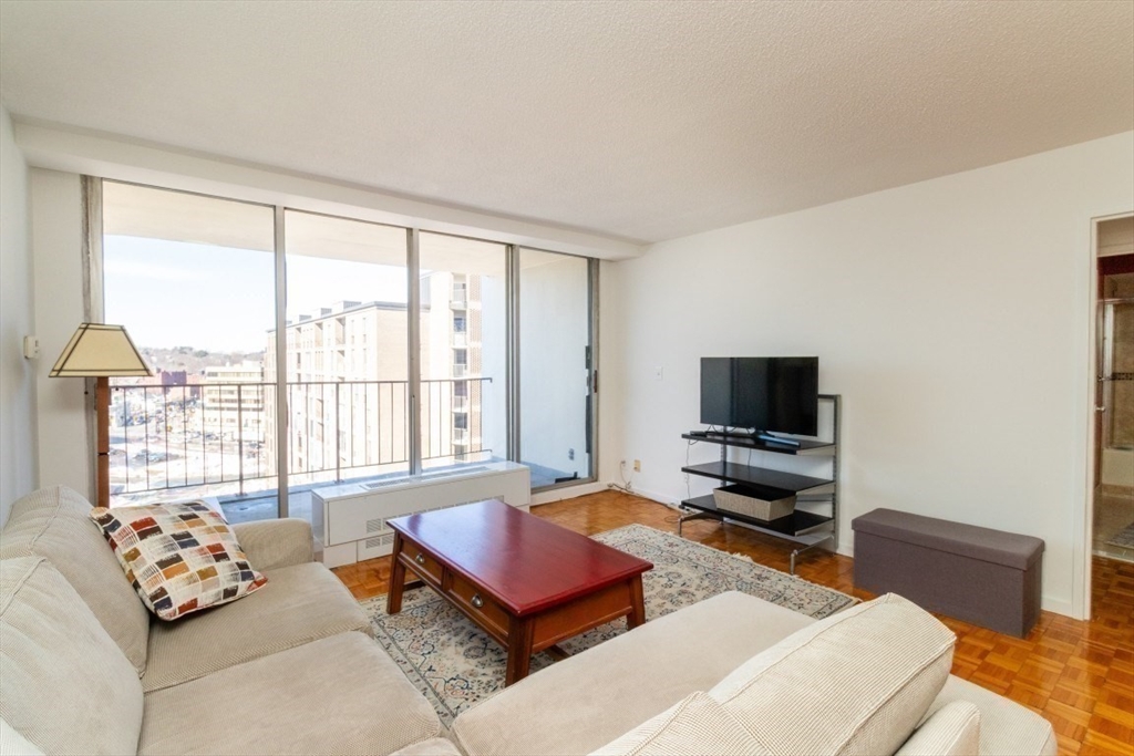 33 Pond Avenue, Unit 1106 Brookline, MA 02445 - Photo 17 of 32 a living room with furniture and a flat screen tv