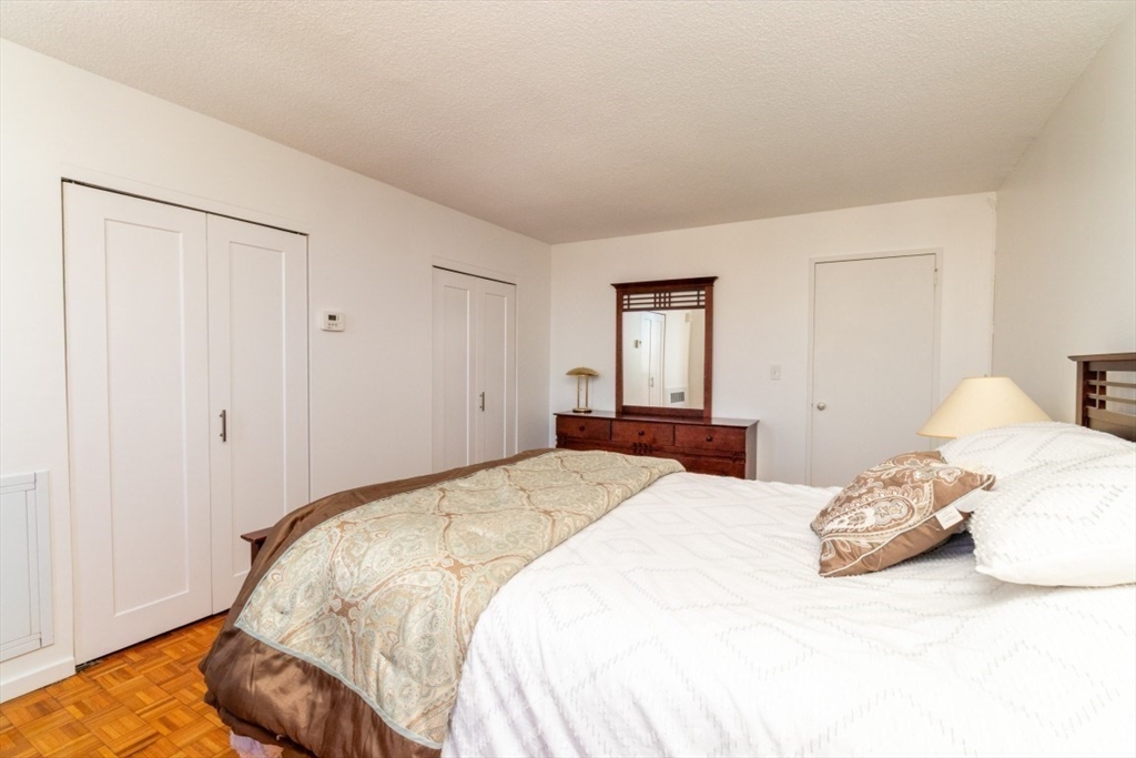33 Pond Avenue, Unit 1106 Brookline, MA 02445 - Photo 18 of 32 a bedroom with a bed and closet