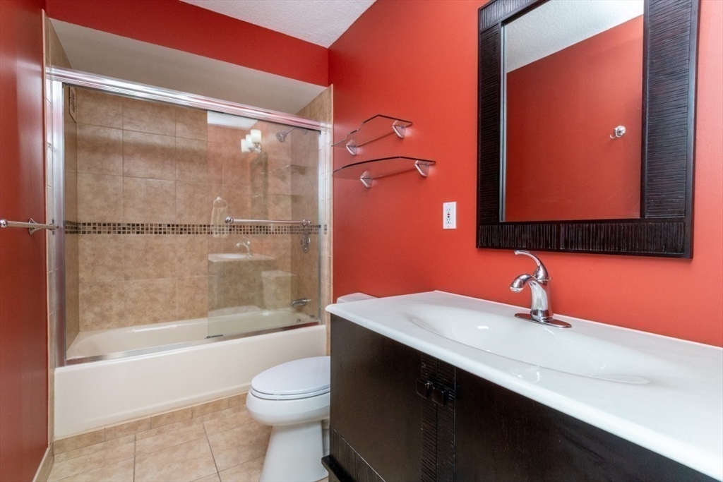 33 Pond Avenue, Unit 1106 Brookline, MA 02445 - Photo 22 of 32 a bathroom with a sink a toilet and shower
