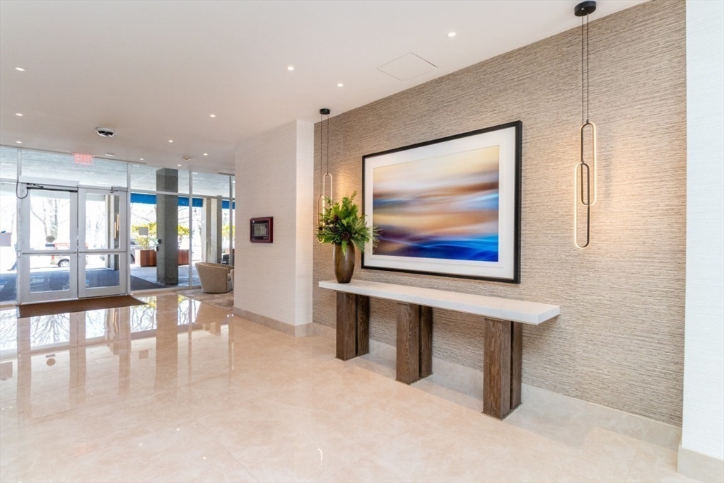 33 Pond Avenue, Unit 1106 Brookline, MA 02445 - Photo 3 of 32 a view of an empty room with furniture and a painting