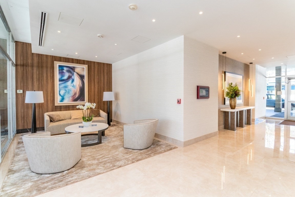 33 Pond Avenue, Unit 1106 Brookline, MA 02445 - Photo 4 of 32 a living room with furniture and a large window
