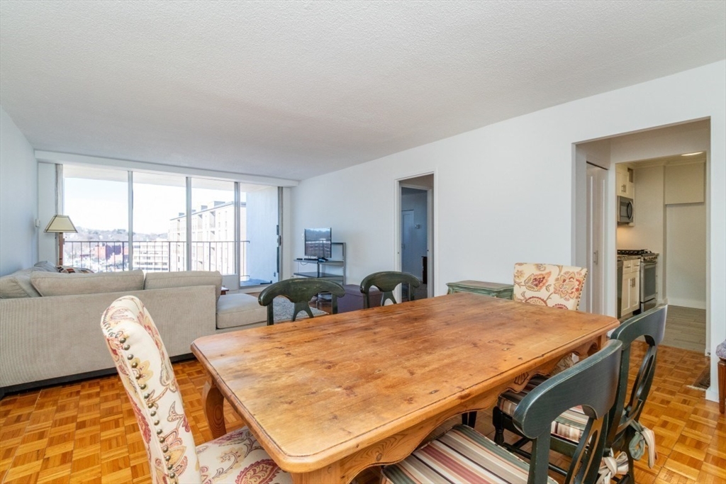 33 Pond Avenue, Unit 1106 Brookline, MA 02445 - Photo 10 of 32 a bed room with furniture and a large window