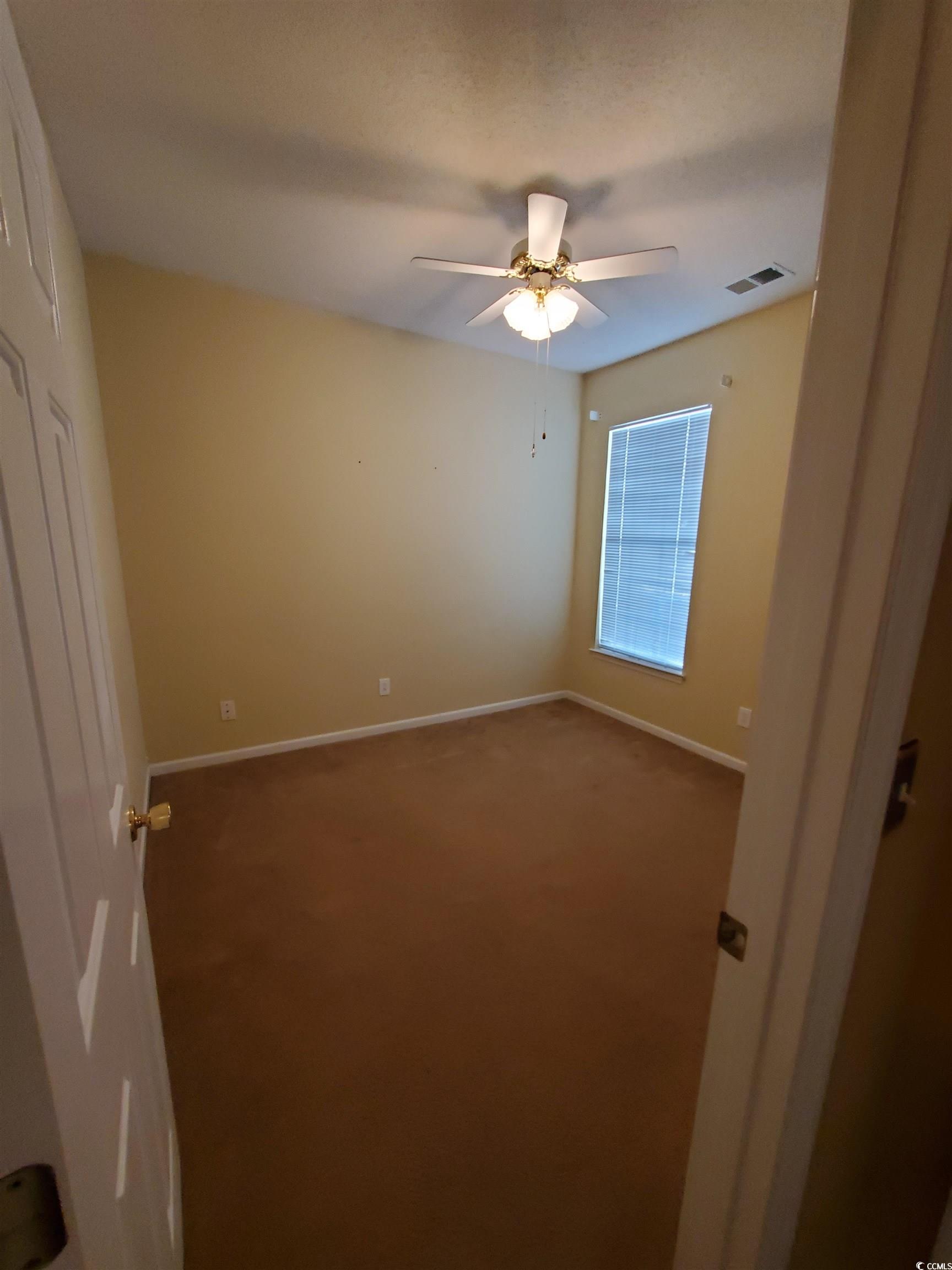219 Spring Lake Drive Myrtle Beach, SC 29579 - Photo 4 of 20 Empty room featuring carpet and ceiling fan