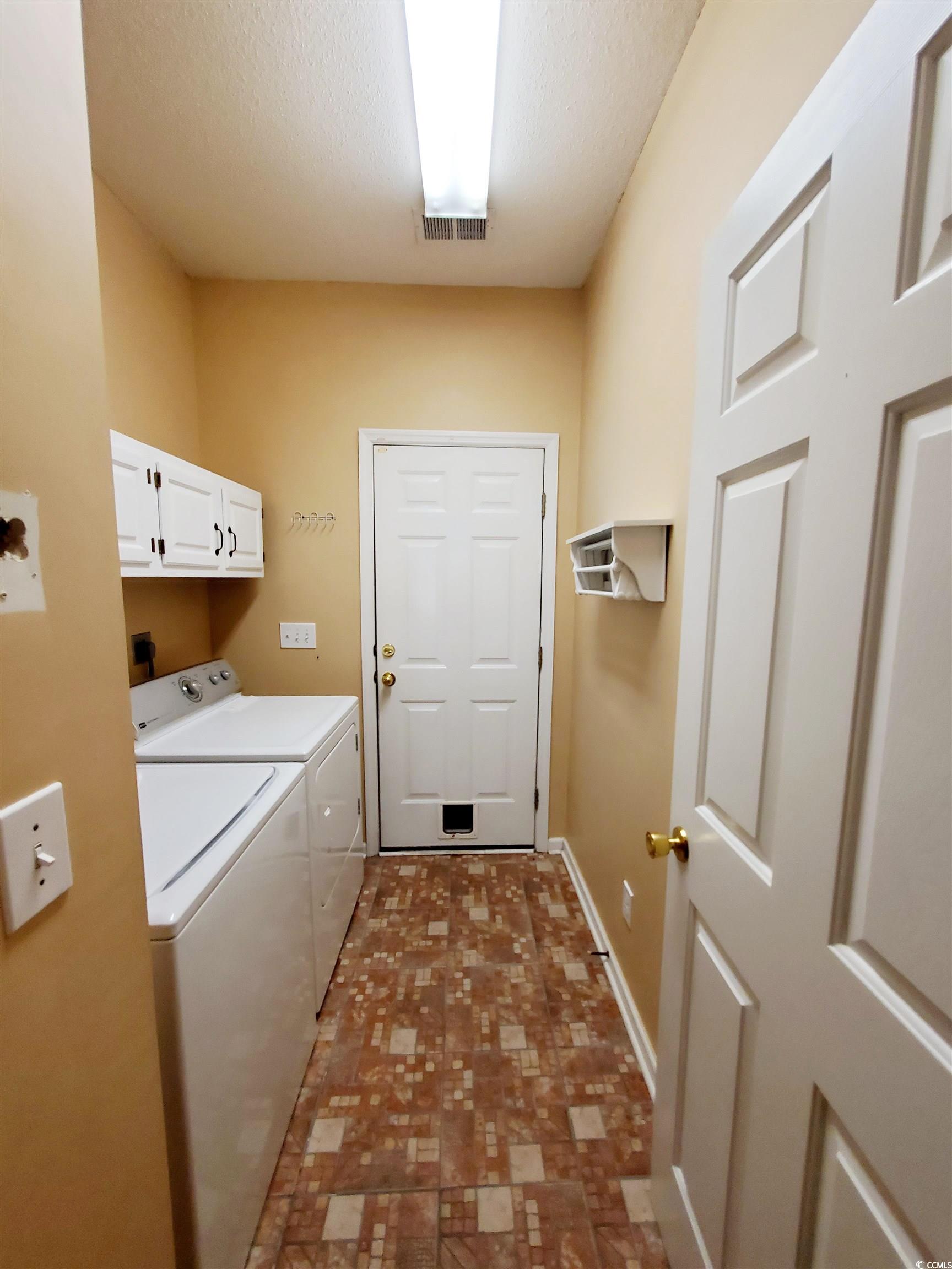 219 Spring Lake Drive Myrtle Beach, SC 29579 - Photo 10 of 20 Laundry room featuring cabinet space, independent washer and dryer, and a textured ceiling