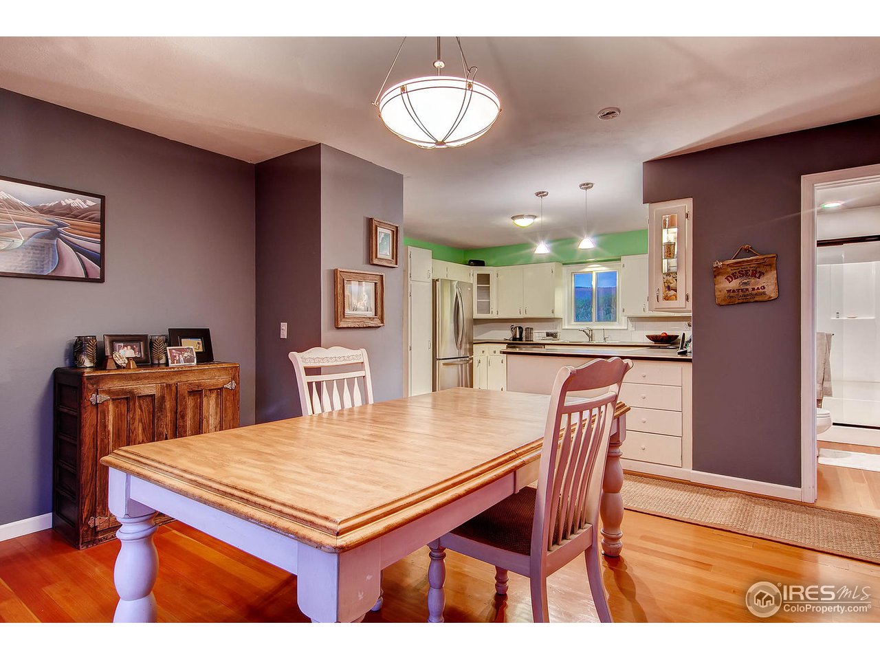 427 Red Gulch Road Lyons, CO 80540 - Photo 13 of 25 a view of a dining room with furniture and wooden floor