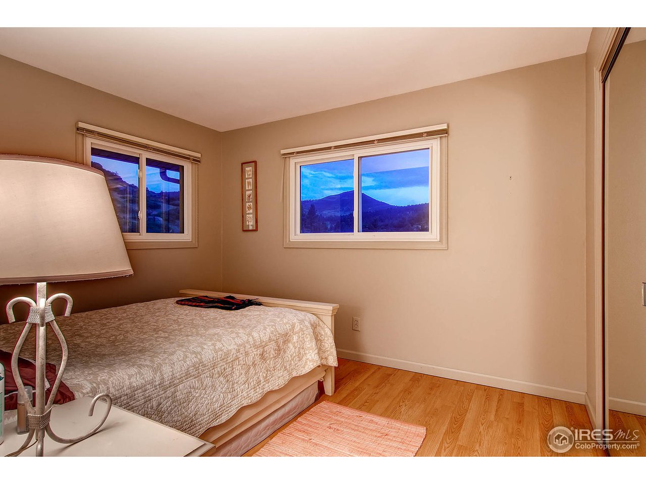 427 Red Gulch Road Lyons, CO 80540 - Photo 14 of 25 a bedroom with a bed and a desk