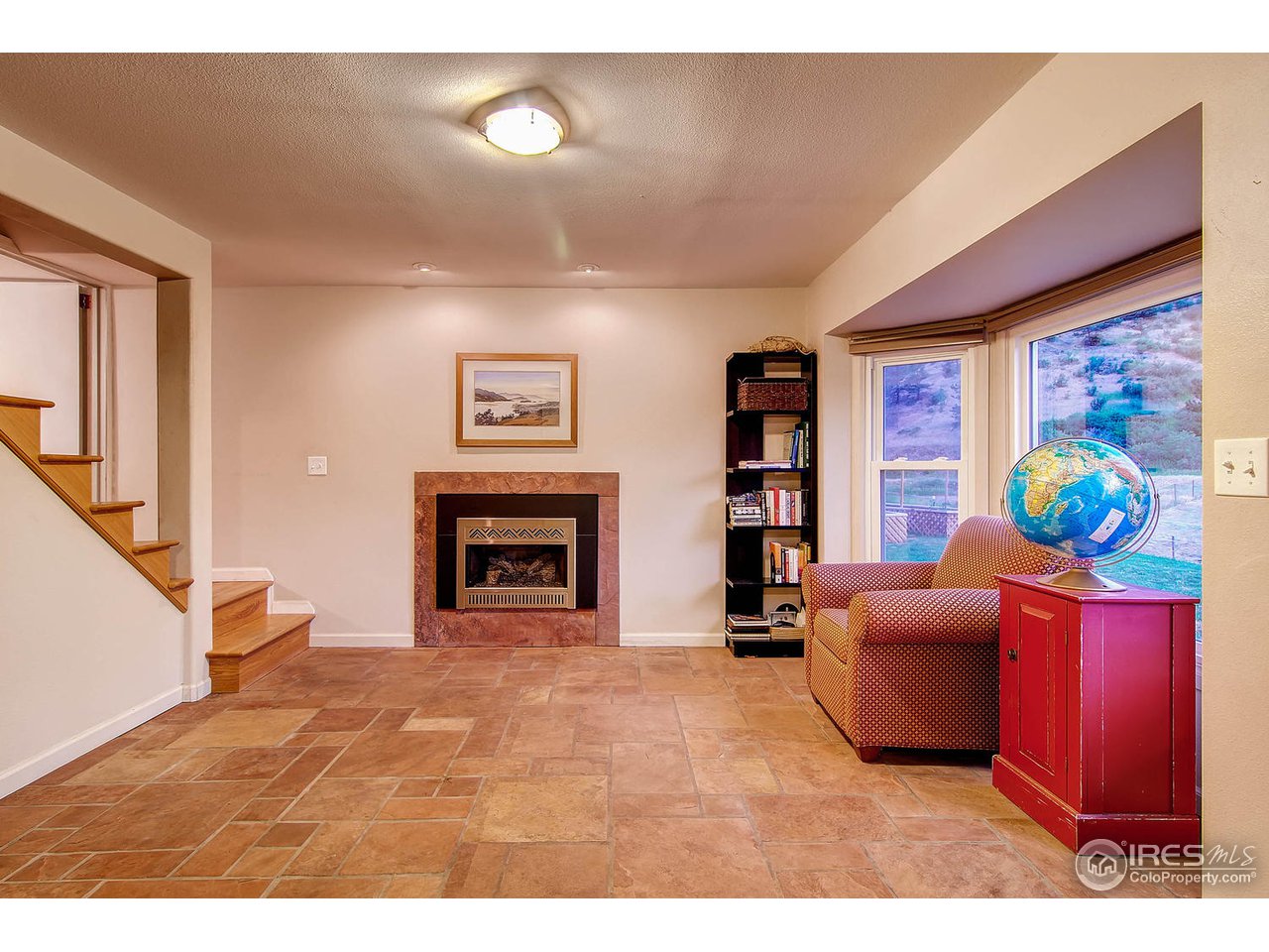 427 Red Gulch Road Lyons, CO 80540 - Photo 18 of 25 a living room with furniture a fireplace and a flat screen tv