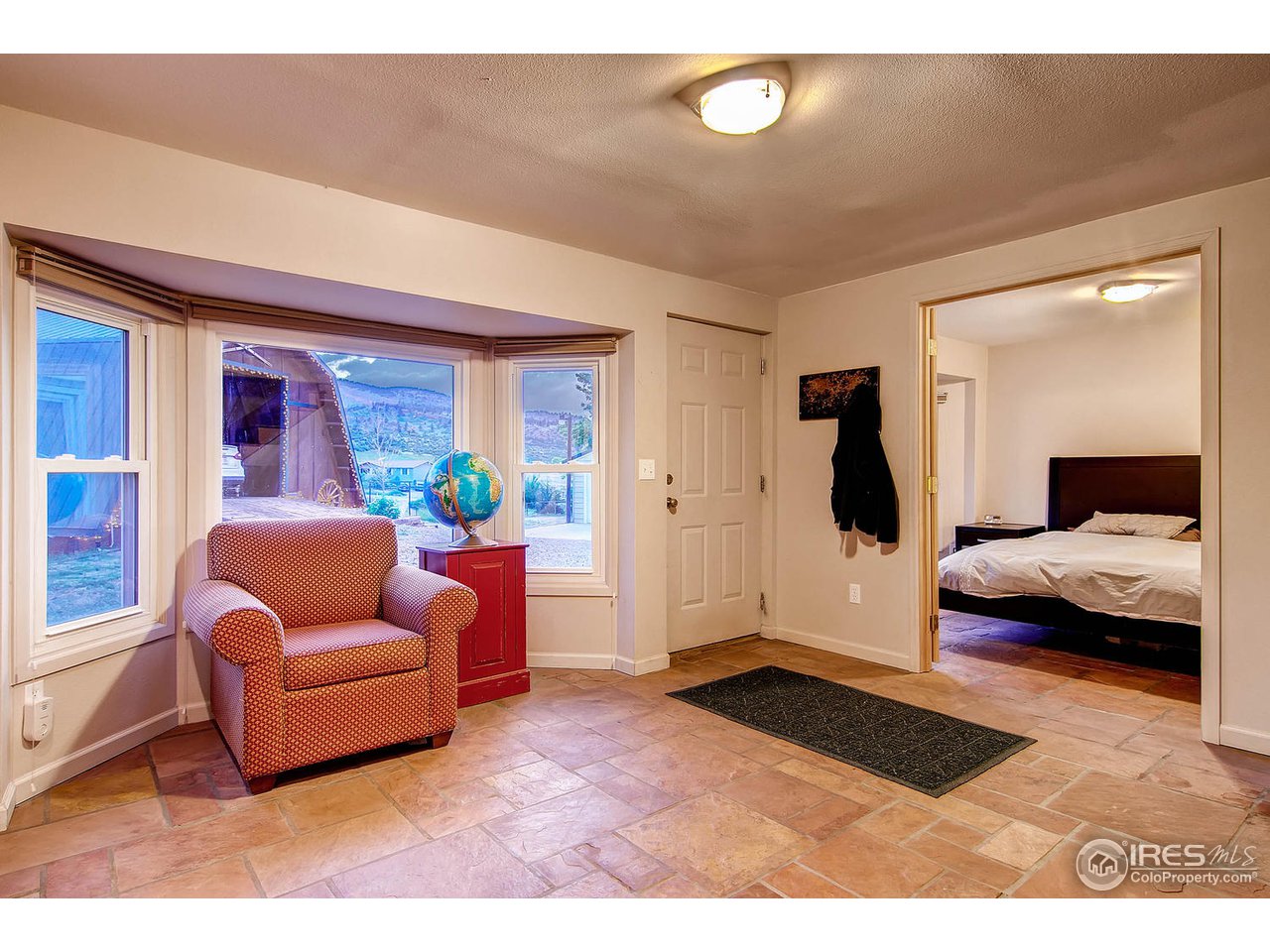 427 Red Gulch Road Lyons, CO 80540 - Photo 19 of 25 a bedroom with furniture and a large window