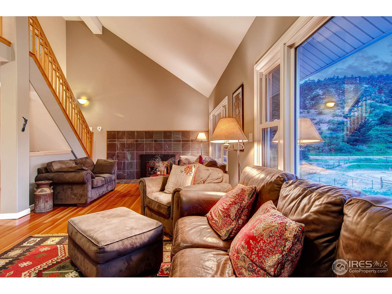 427 Red Gulch Road Lyons, CO 80540 - Photo 5 of 25 a living room with furniture and a floor to ceiling window