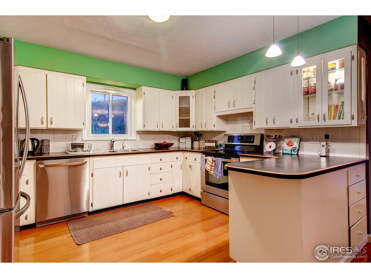 427 Red Gulch Road Lyons, CO 80540 - Photo 10 of 25 a kitchen with stainless steel appliances granite countertop a sink stove and cabinets