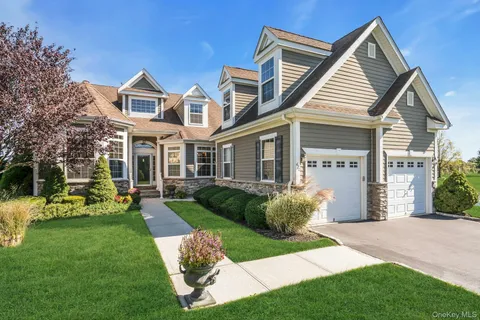 a front view of a house with a yard table and chairs