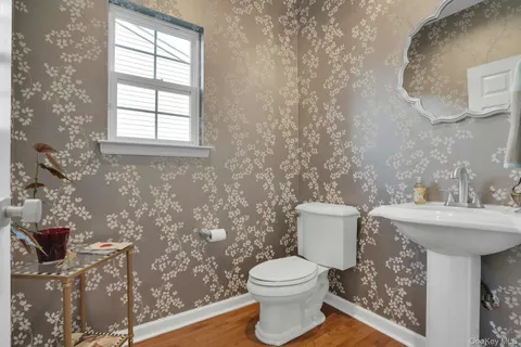 a bathroom with a sink toilet and window