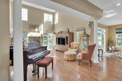 a living room with furniture fireplace and a table