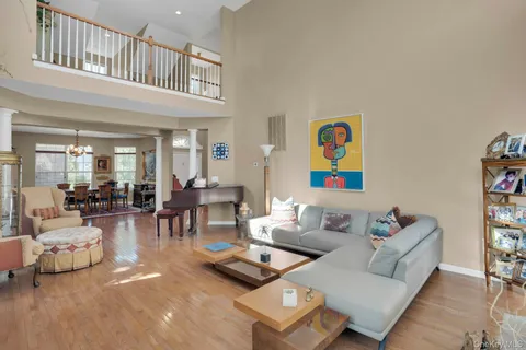a living room with furniture and a book shelf