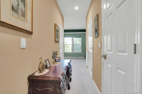 a kitchen with granite countertop a stove a sink a refrigerator wooden floor and cabinets