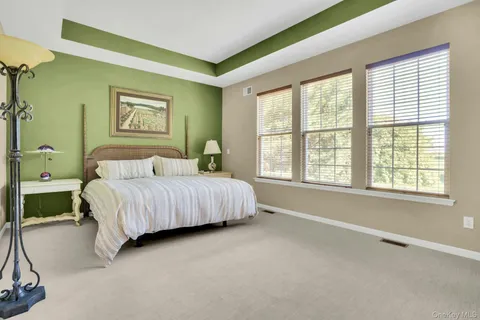a view of a hallway with workspace and mirror