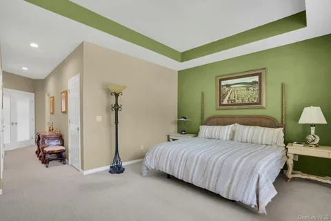 a bedroom with a bed mirror and window