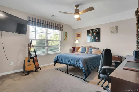 a bedroom with furniture and a window