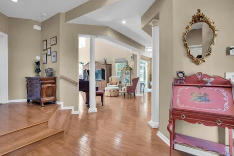 a view of living room filled with furniture and wooden floor