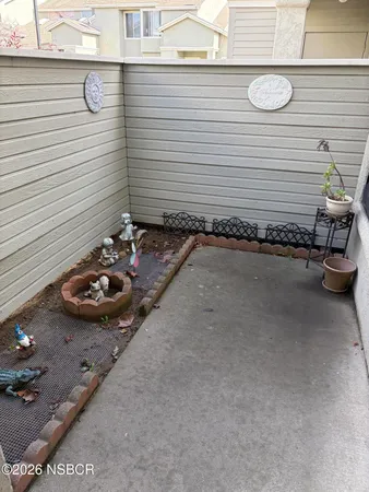 a view of a chairs and table in a backyard