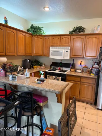a kitchen with a stove a sink dishwasher and a refrigerator