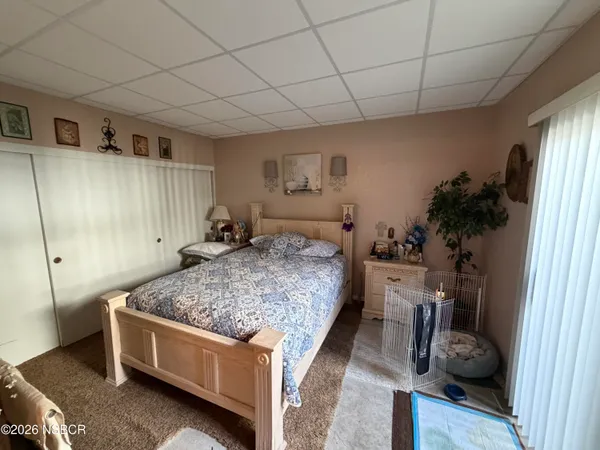 a bed room with a bed and a window