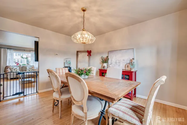 a view of a dining room with furniture wooden floor and chandelier