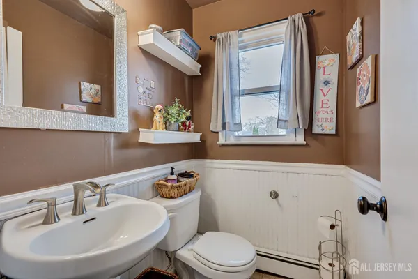 a bathroom with a sink a mirror and a toilet