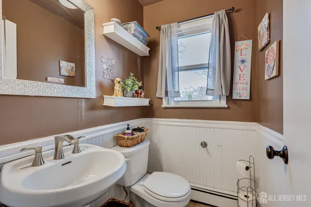 a bathroom with a sink a mirror and a toilet