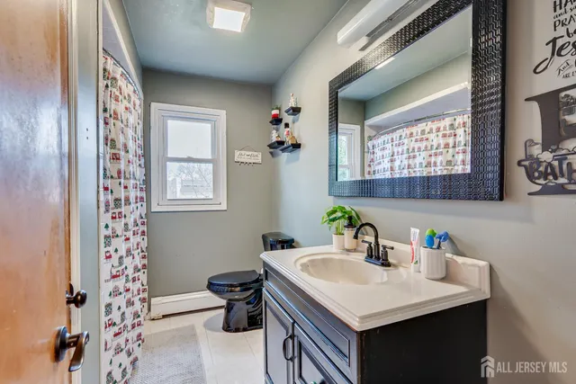 a bathroom with a sink toilet and a mirror