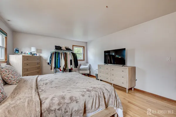 a bedroom with a bed and flat screen tv