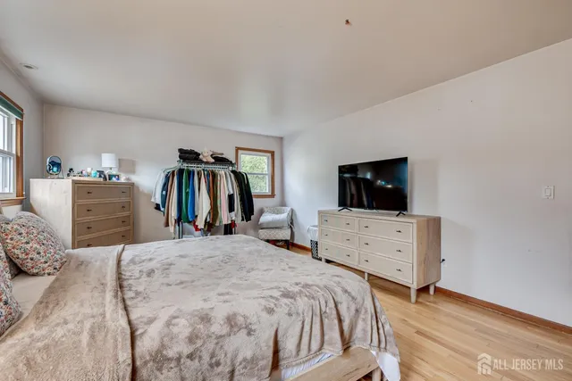 a bedroom with a bed and flat screen tv