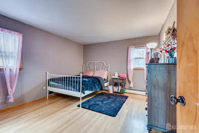 a bedroom with furniture and a window