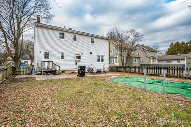 a view of a white house with a yard