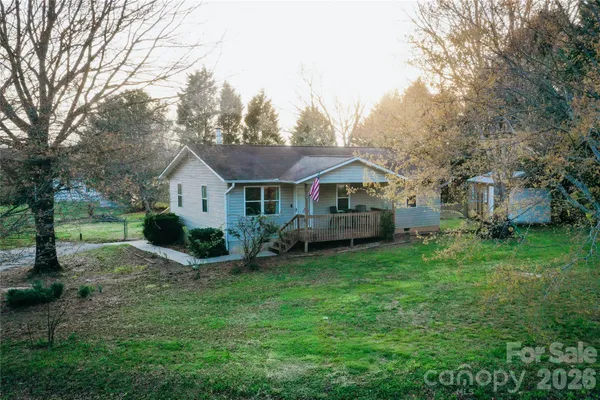 a front view of house with yard and green space