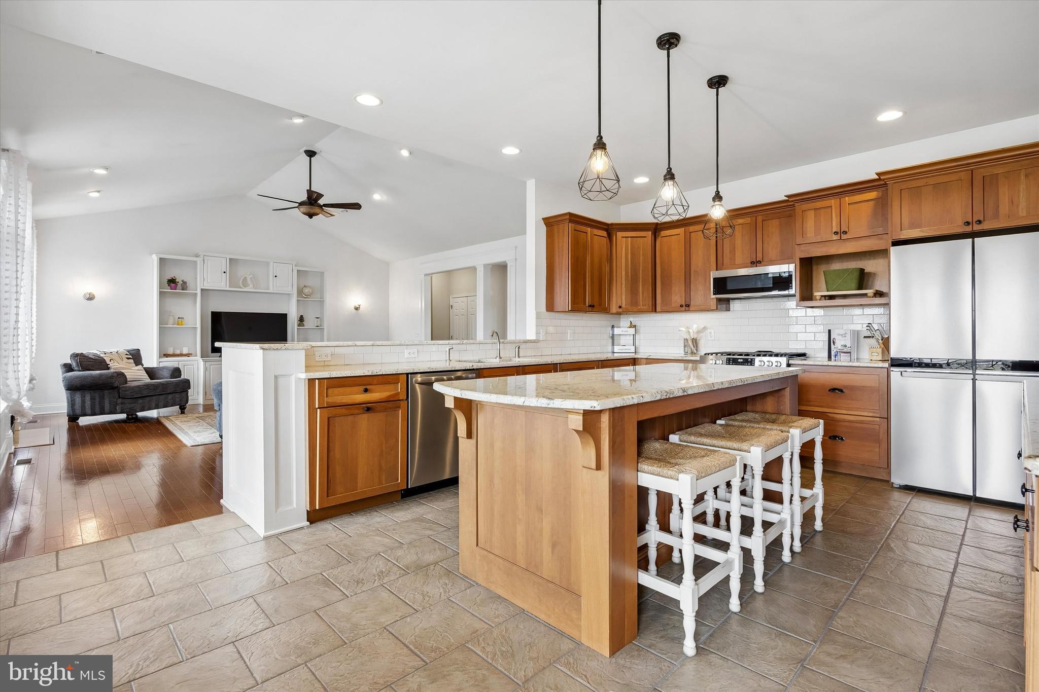 706 Kings Highway Mannington, NJ 08079 - Photo 16 of 35 a kitchen with stainless steel appliances kitchen island granite countertop a table chairs and a refrigerator