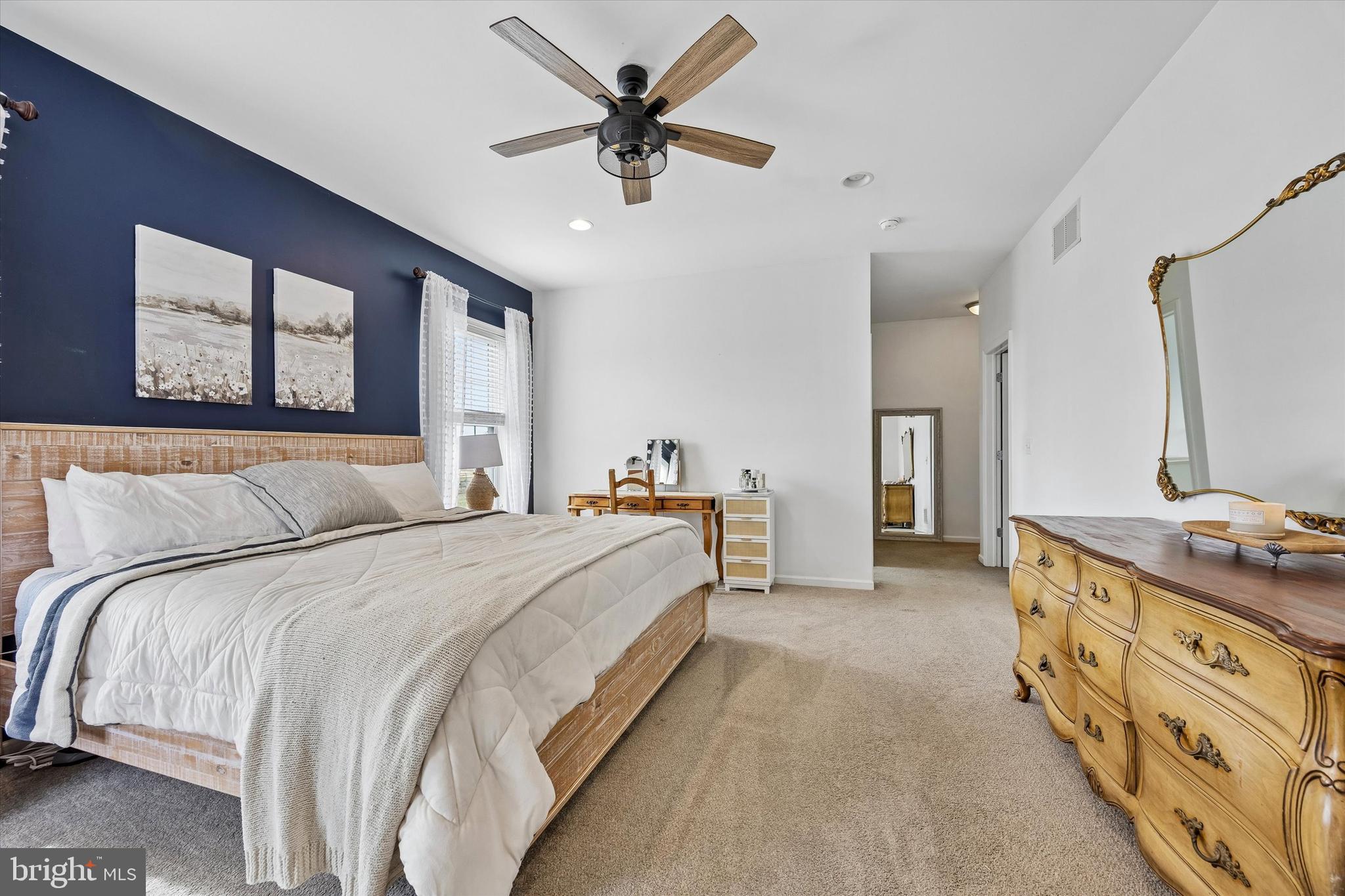 706 Kings Highway Mannington, NJ 08079 - Photo 22 of 35 a spacious bedroom with a bed and a chandelier