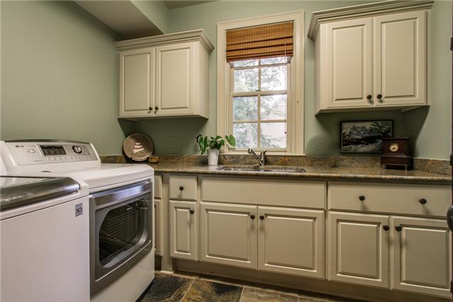 123 Page Road Nashville, TN 37205 - Photo 11 of 20 A large laundry room downstairs has an amplitude of cabinet space and rinsing sink.