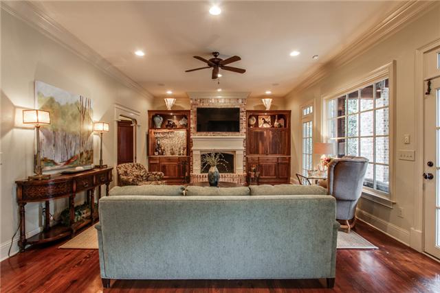 123 Page Road Nashville, TN 37205 - Photo 6 of 20 This gorgeous living room boasts a wood burning fireplace, built-in shelving, a built-in wet bar, and access to the backyard!