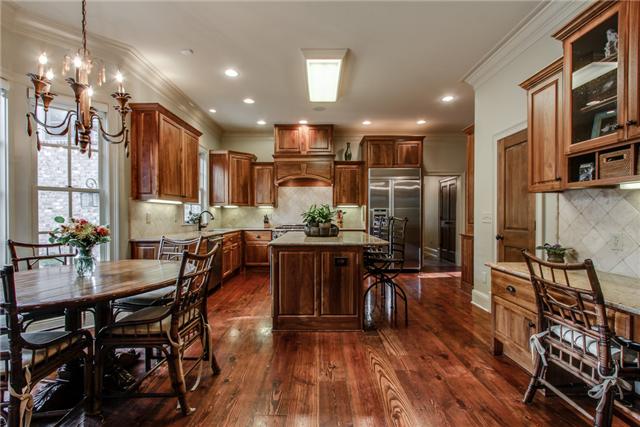 123 Page Road Nashville, TN 37205 - Photo 8 of 20 This very open concept kitchen has a great breakfast nook, built-in desk, walnut cabinets, and high-end stainless steel appliances.