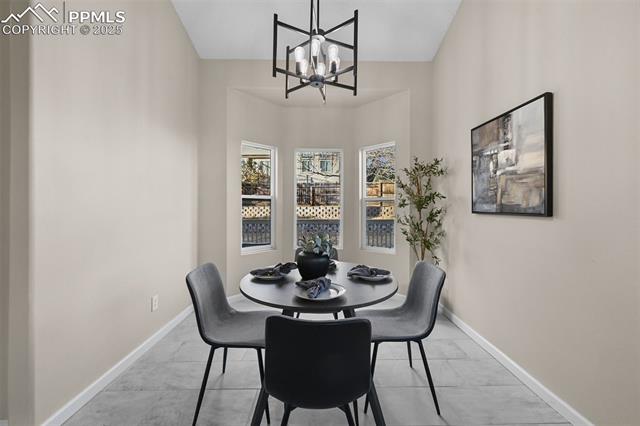 5428 Rondo Way Colorado Springs, CO 80911 - Photo 9 of 43 Dining area with baseboards and a chandelier
