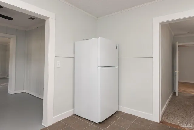 a view of a kitchen with refrigerator and two cabinet