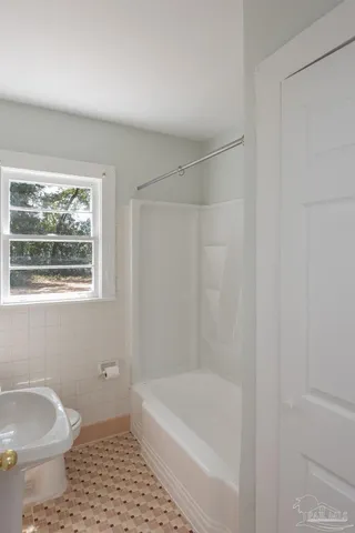 a bathroom with a shower and a bath tub