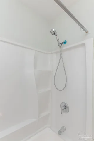 a view of a field with trees in the background