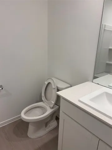 a white toilet sitting next to a white sink