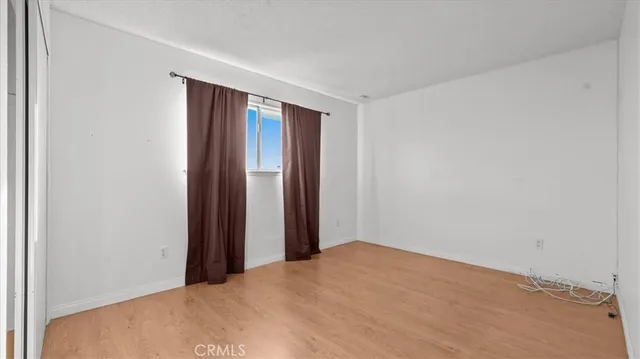 a view of a room with a wooden floor and bathroom