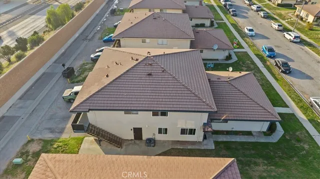 an aerial view of a house with a yard
