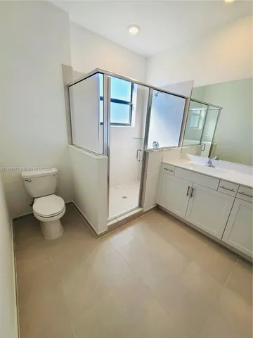 an empty room with closet and mirror